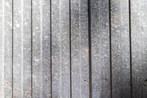 Aluminum fence. Corrugated metal profiled panel. Background of grey metal siding, corrugated iron sheet for exterior decoration