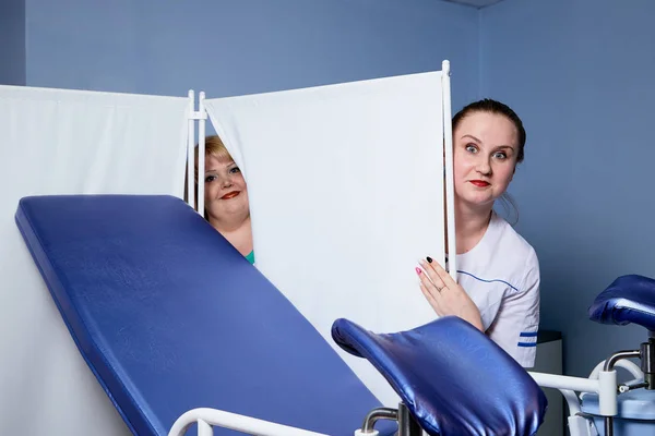 Experienced doctor fat woman teaching aspiring young doctor how to do peculiarities of medical work