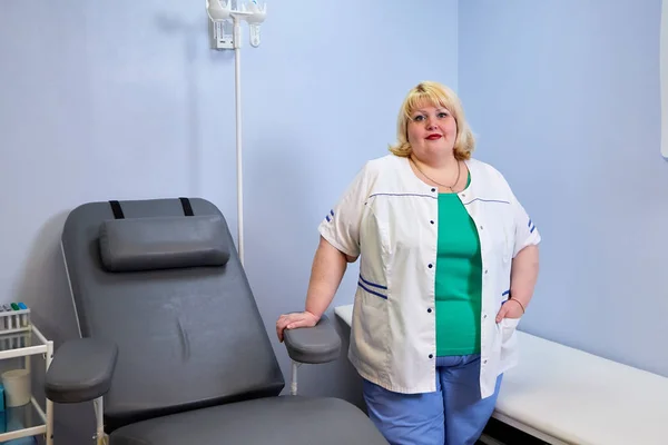 Portrait of experienced doctor fat woman in medical office