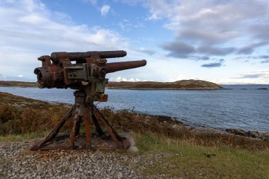 A WWII era deck gun from an armed merchant ship, overlooking the sea on the Isle of Coll in Argyll and Bute, Scotland