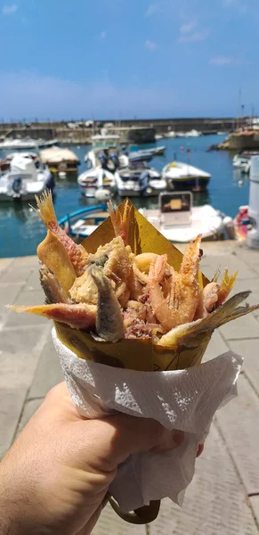Street food, fried fish eaten at the port of the small village of Camogli in Liguria.