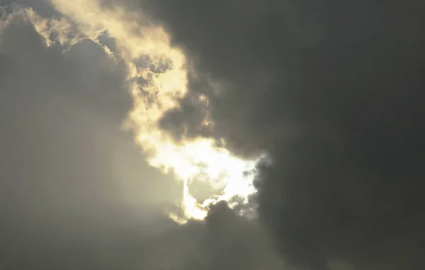 sunlight through from dark rain cloud on sky