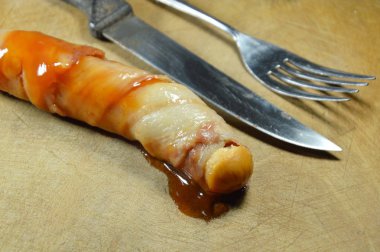 pastırma domuz sosis sosu ketçap ve chili sos ahşap kesme blok üzerinde rulo