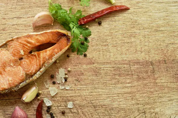 Риба на грилі з сіллю та перцем на дерев'яному фоні — стокове фото