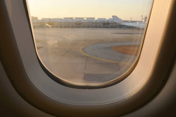 view from plane window landing on airport