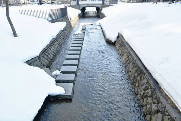 snow melting down fall to canal in Hokkaido Japan