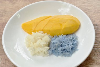  plaka üzerinde beyaz ve Mor yapışkan pirinç soyunma Hindistan cevizi sütü ile mango olgunlaşmak