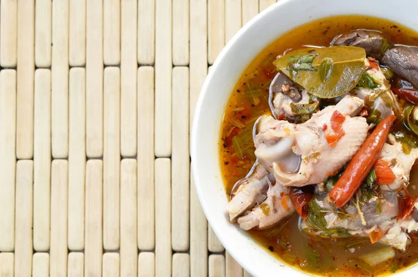 stock image  boiled chicken bone with herb and tamarind leaf Thai spicy soup on bowl