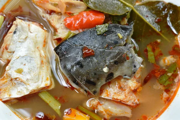 Boiled salmon fish in spicy tom yum soup on bowl — Stock Photo, Image