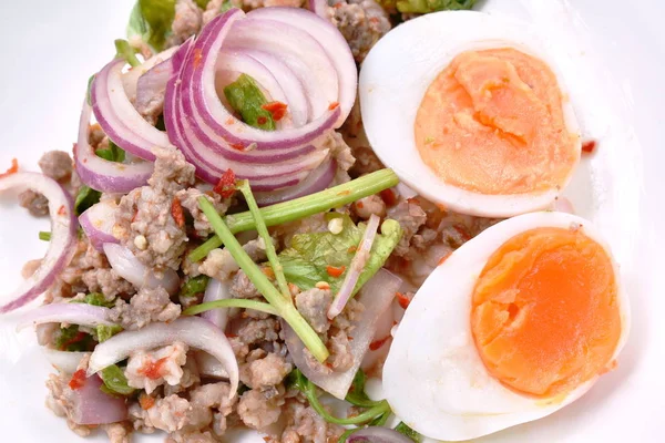 Boiled egg half cutting topping sour and spicy minced pork salad on plate — Stock Photo, Image