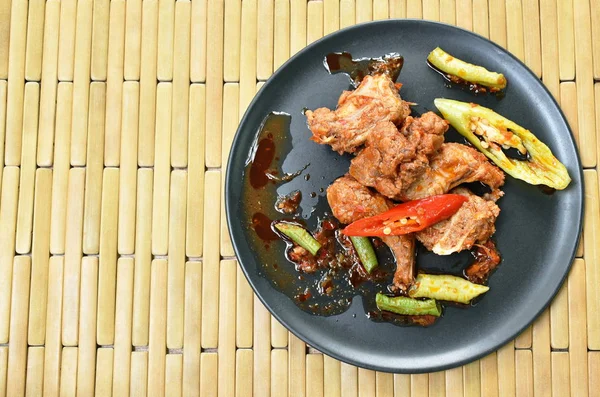 Piccante mescolare l'osso di maiale fritto con peperoncino e fagiolo lungo cinese sul piatto — Foto Stock