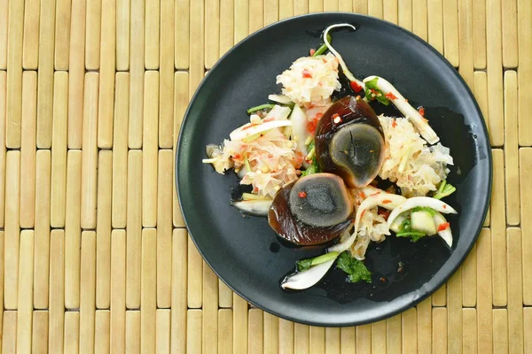 Oeuf confit bouilli demi-coupé avec salade thaïlandaise aux champignons blancs sur assiette — Photo