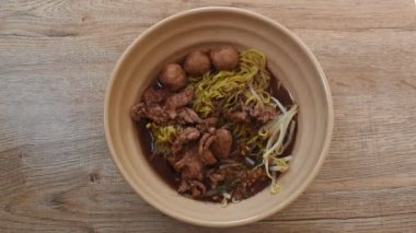 Yumurtalı şehriyeli domuz köftesi, kahverengi çorba, kaşık kaşık ve çubuklarla kepçeleme.