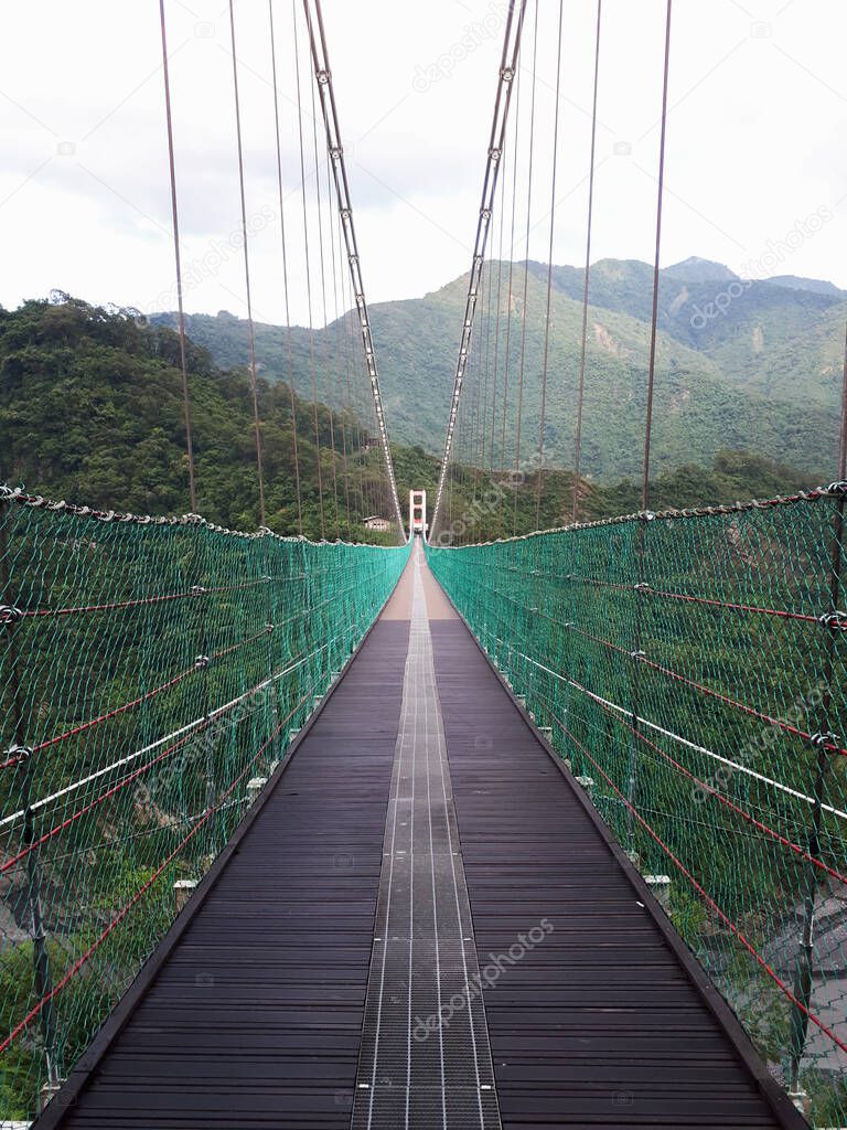 Straight suspension bridge in the valley