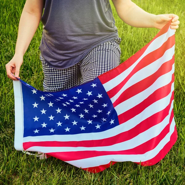 American flag and Black Lives Matter text, slogan on a piece of paper supporting African Americans in the United States