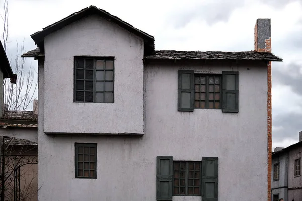 Ancient house in european medieval style on a background of gray cloudy sky