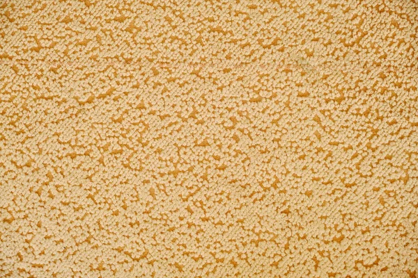 Carpet texture with orange dots, close up. Fabric texture with spots. Textile material background with abstract pattern.