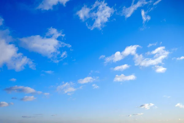 Cloudy sky in clear weather, copy space. Cumulus cloud on a sunny winter day. White clouds against a blue sky.
