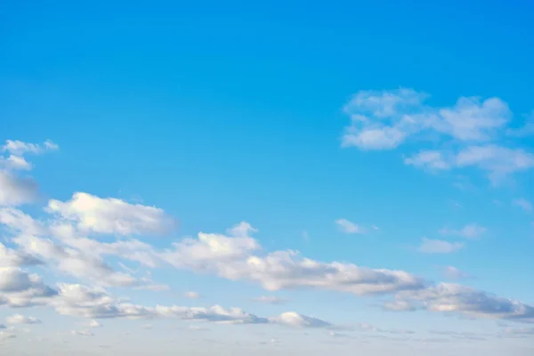 White cumulus clouds in clear weather, copy space. The sky on a Sunny summer day. Background clouds on blue sky.