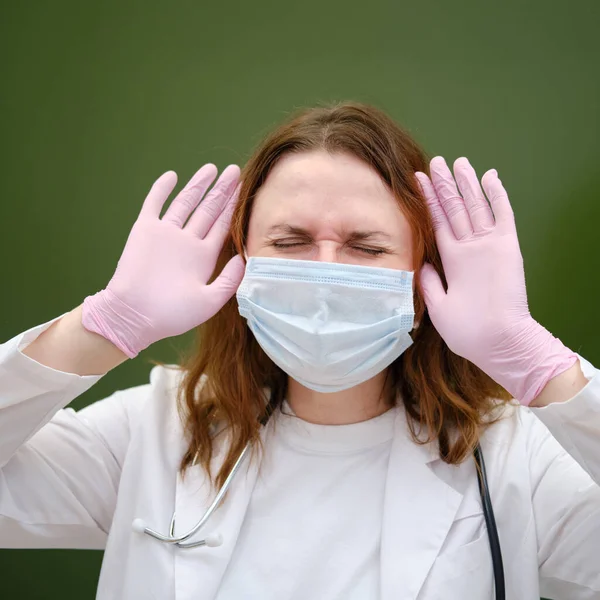 Upset doctor in face mask at school chalkboard. School quarantine education concept