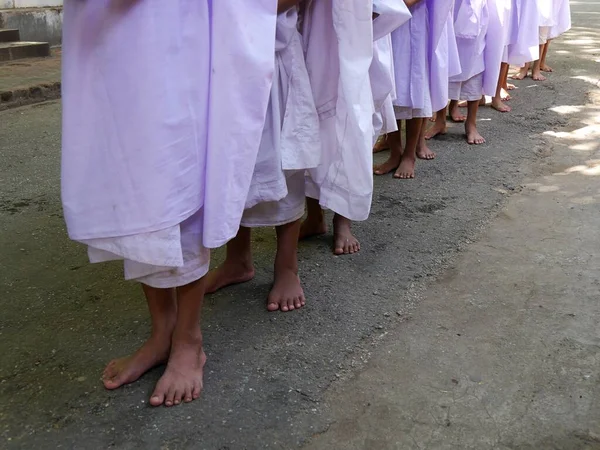 Sluiten van de voeten van rij van beginnende nonnen in lila gewaden, Myanmar — Stockfoto