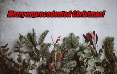 Positive Merry unprecedented Christmas message for Christmas 2020 with pandemic, with holly and pine leaves. Ample copy space. High quality photo clipart