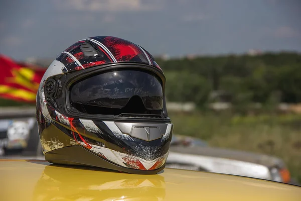 Protective helmet for car rally on the roof of a car summer day