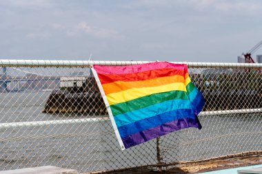 Rainbow flag for LGBT pride in fence clipart