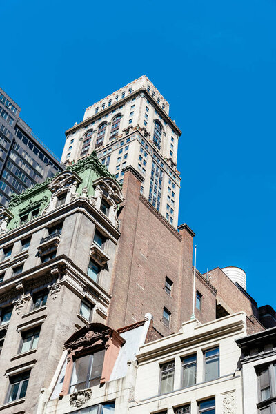 New York City, USA - June 20, 2018: Low angle view of old buildings against sky in Midtown of Manhattan