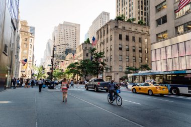 Scenic view of Fifth Avenue in New York City with people and yel clipart