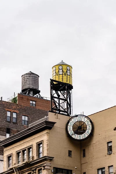 Vista ad angolo basso delle torri d'acqua e dell'orologio contro il cielo a New York — Foto Stock