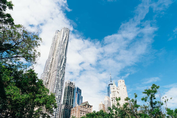 New York City, USA - June 20, 2018: Low angle view of skyscrapers against blue sky in Financial District of New York