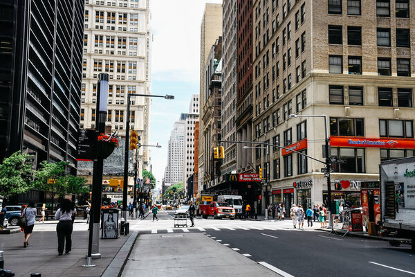 New York City, USA - June 20, 2018: View of Broadway with Liberty Street in Financial District in Lower Manhattan