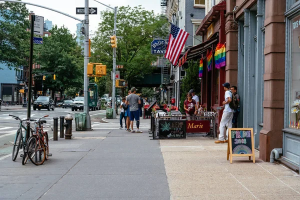 Sidewalk cafe decorated with gay pride rainbow flags — Stock Photo, Image