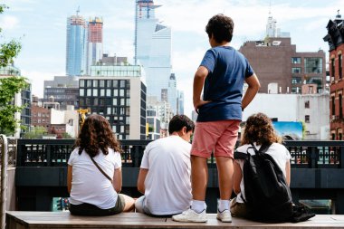 Young people sitting on High Line in New York clipart
