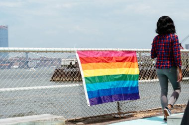 Rainbow flag for LGBT pride in fence in promenade in Governors I clipart