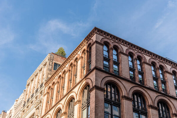 New York City, USA - June 25, 2018: Low angle view against blue sky of typical building in Soho Cast Iron historic District in New York City