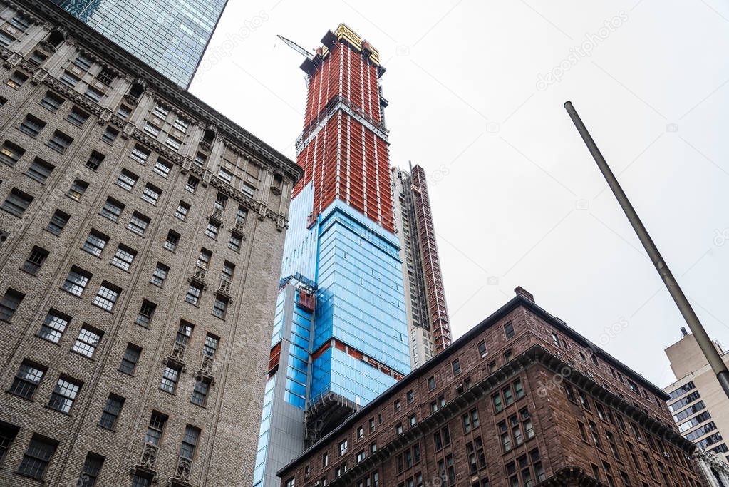 Low angle view of buildings and skyscraper under construction