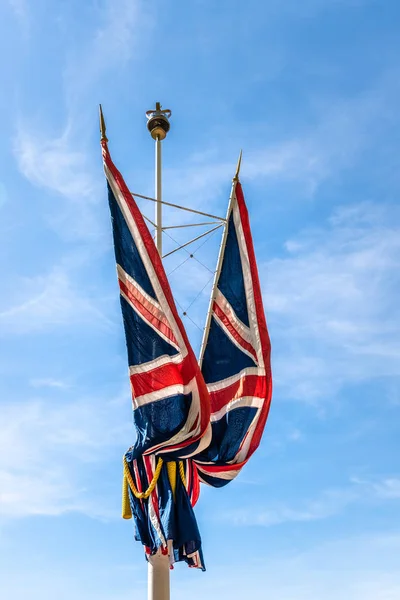 Drapeaux Union Jack agitant contre le ciel bleu — Photo