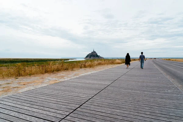 Turisti a piedi lungo la strada per Mont Saint-Michel — Foto Stock