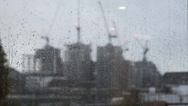 Rain Falling Window Blurred Construction Cranes Background Locked — Stock Video