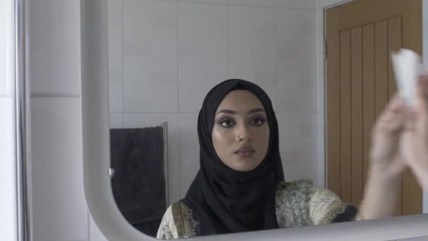 Muslim Woman Wiping Bathroom Mirror Using Tissue Locked — Stock Video