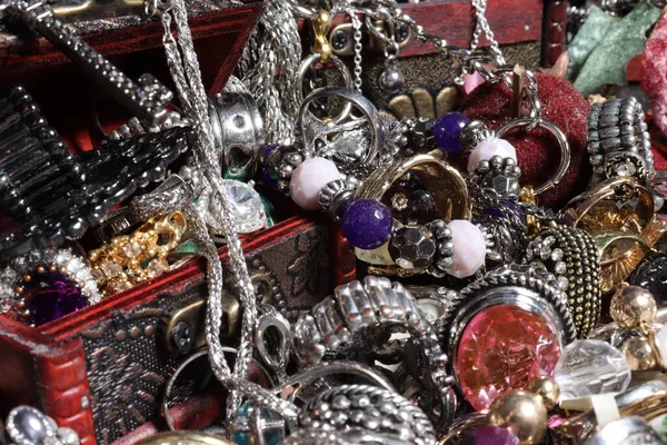 Several jewels in different chests with rings, necklaces, bracelets of different sizes and colors