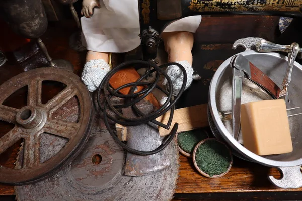 Different period products, doll, reel, cauldron, wallet, thread, cup of tea, knife, soap