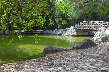 Yunanistan 'ın başkenti Atina' nın ulusal bahçesindeki göl ve ahşap köprü manzarası