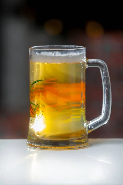 Glass of beer on a background of illumination