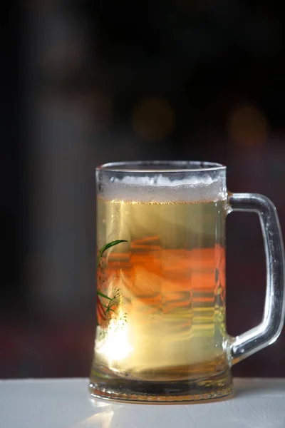 Glass of beer on a background of illumination