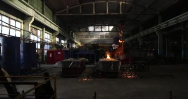 Demir ve Çelik Fabrikası. Erimiş Demir Dökümü. Metal endüstrisi, erimiş metal, parlayan çelik endüstrisi, erimiş çelik, eriyen çelik, metalurji fabrikası, kırmızı-sıcak metal üretimi, sıcak metal üretimi,
