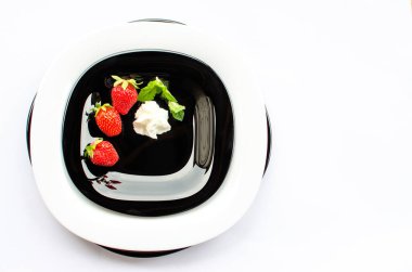 Tatlı olarak kırmızı lezzetli çilekler ve sınırlı bir arkaplanda dondurma için taze meyve suyu.