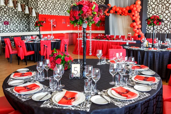 serving of the wedding table, beautiful festive decor in red